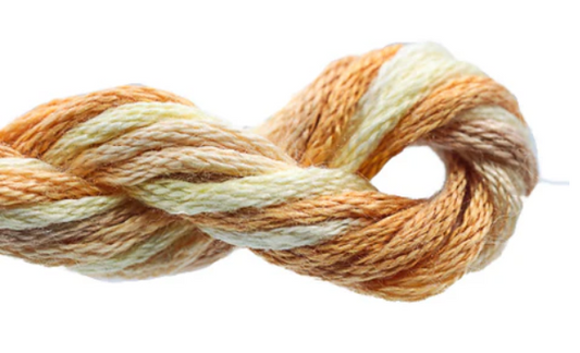 Coiled skein of yarn with beige and white colors on a white background