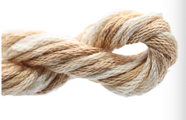 Ball of beige and brown yarn on a white background
