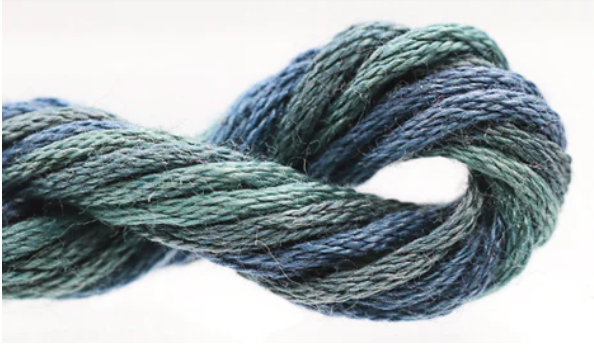 Blue and green skein of yarn on a white background