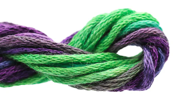 Close-up of green and purple yarn on a white background