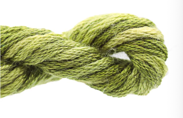 Close-up of green yarn tied in a knot on a white background