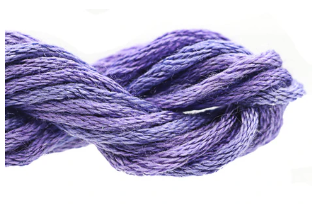 Close-up of purple embroidery floss on a white background