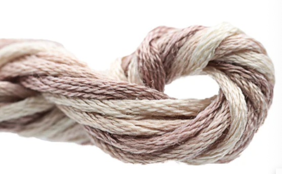 Close-up of a skein of yarn with a neutral color palette on a white background