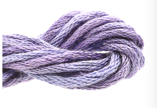 Close-up of a ball of purple yarn on a white background
