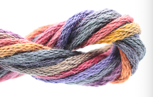 Multicolored skein of yarn on a white background