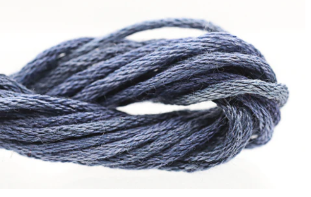 Close-up of a ball of blue yarn on a white background