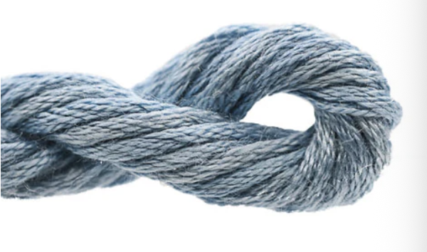 Close-up of a skein of blue yarn on a white background