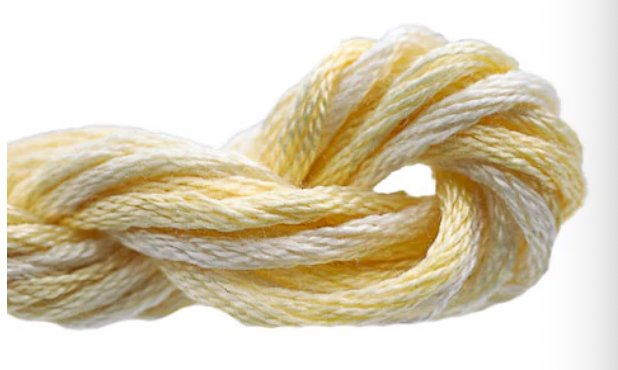 Coiled yellow and white yarn on a white background