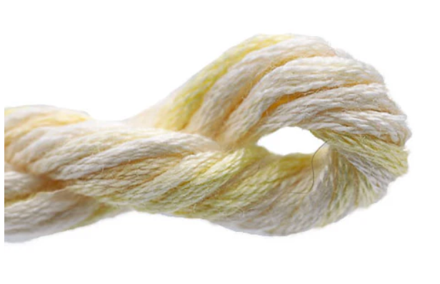 Close-up of a skein of light-colored yarn on a white background