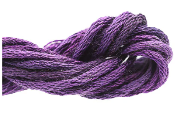 Close-up of purple embroidery floss on a white background