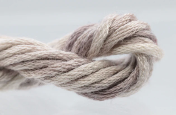Coiled skein of yarn on a light gray background