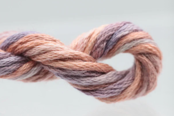 Multicolored skein of yarn on a light gray background