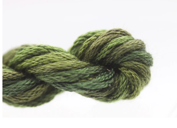 Green skein of yarn on a white background