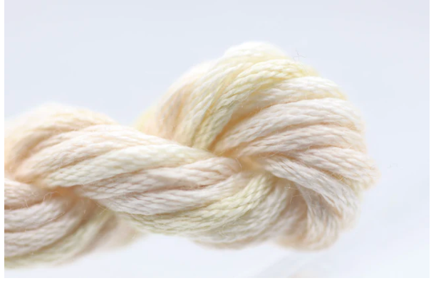 Cream-colored yarn skein on a light gray background