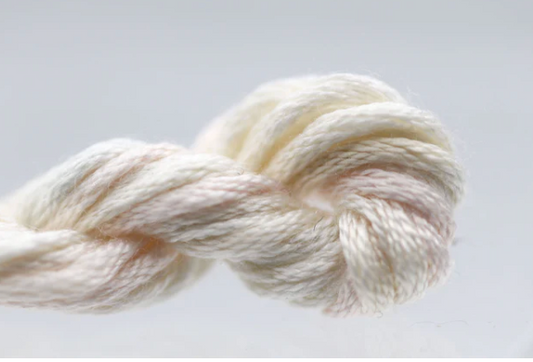 White skein of yarn on a light gray background