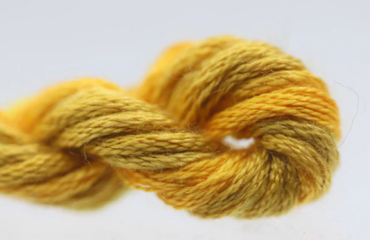 Yellow skein of yarn on a white background