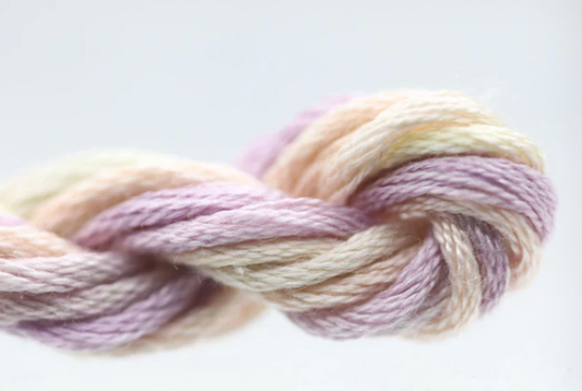 Pastel-colored yarn skein tied in a knot on a light background