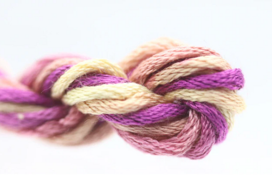 Braided rope with pink, purple, and beige colors on a white background