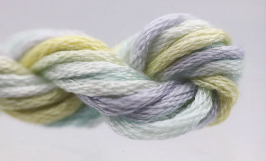 Multicolored yarn skein on a light gray background