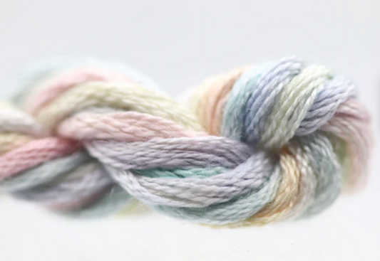 Pastel-colored yarn skein on a light background