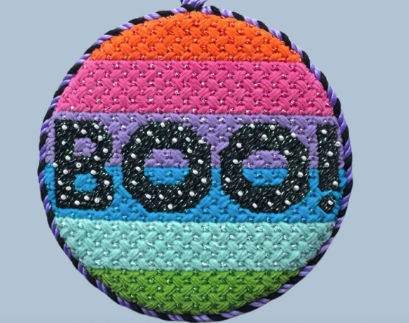 Colorful round patch with 'BOO!' text on a light blue background