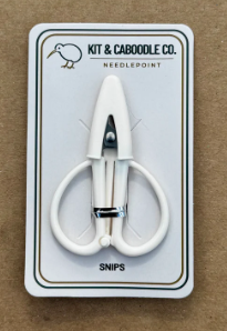 White snips on a Kit & Co. branded card against a brown background