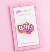 Pink lapel pin with 'wip' on a matching card, branded 'glitterlina'.