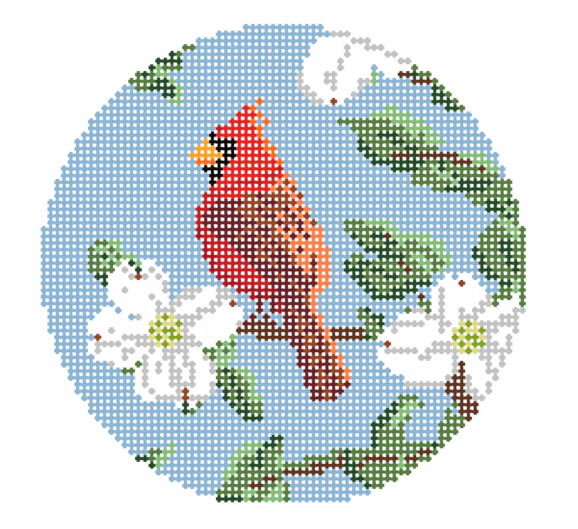 Cross-stitched design of a red cardinal bird with green leaves and white flowers on a blue background.