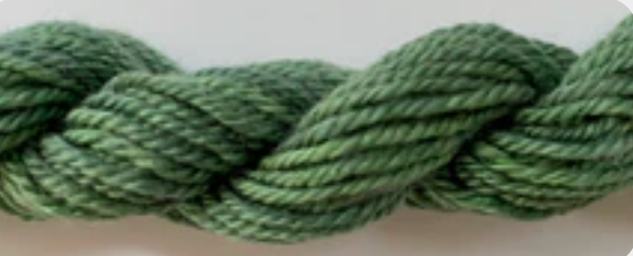 A close-up of a thick, twisted skein of green yarn or cord