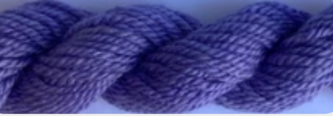 A close-up of a thick, twisted bundle of purple yarn or wool fiber.