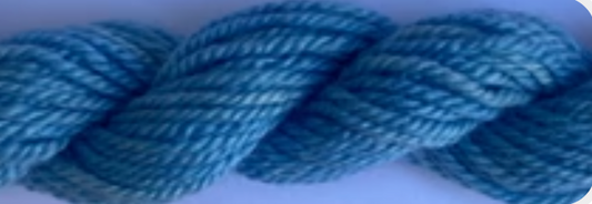 A close-up of a twisted skein of blue yarn against a light purple background.
