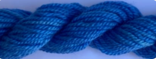 A close-up of a thick, twisted blue rope or cord against a plain light background.