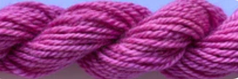 A close-up of a twisted pink yarn or cord skein against a pale lavender background.