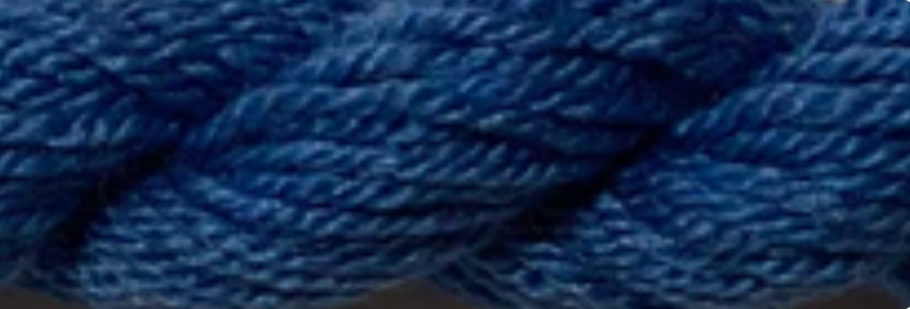A close-up of a thick braided yarn or rope in a deep blue color.