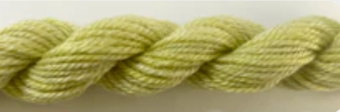 A close-up of a twisted yarn or thread in a pale yellow-green color.