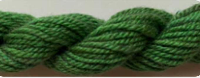 A close-up of a thick, twisted green rope or yarn texture against a plain.