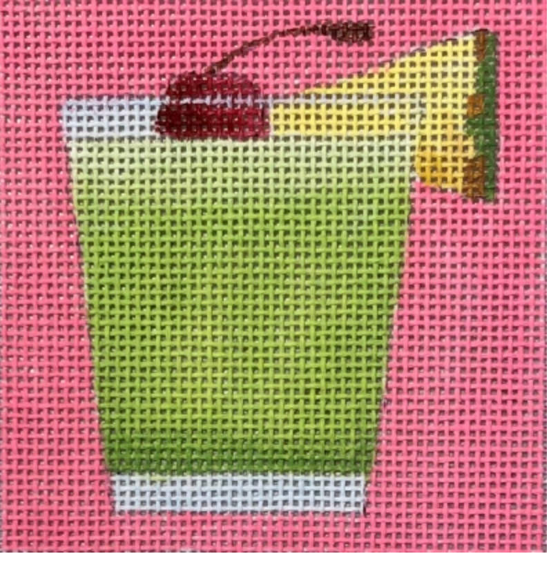 Green cocktail glass with red cherry on pink needlepoint canvas