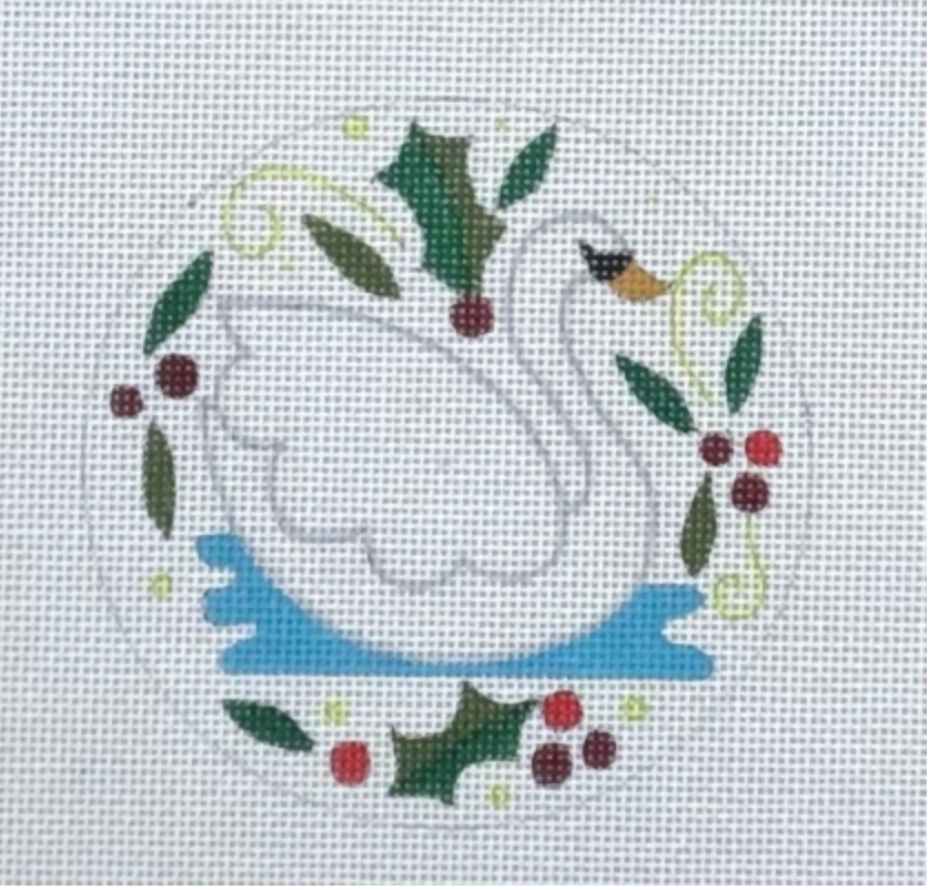 White swan on water with holly leaves and red berries