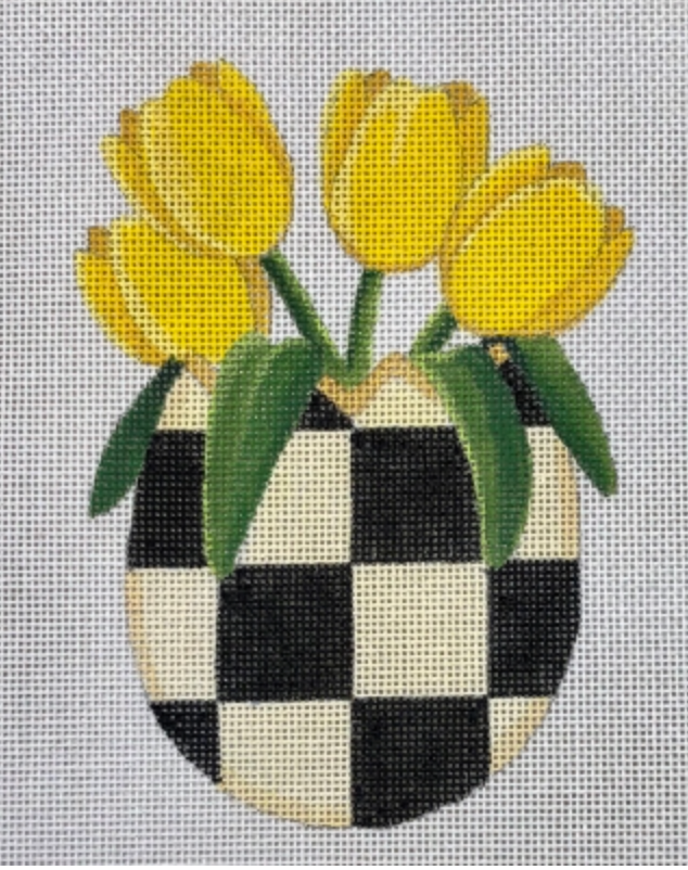 Yellow tulips in checkered vase on light gray grid background