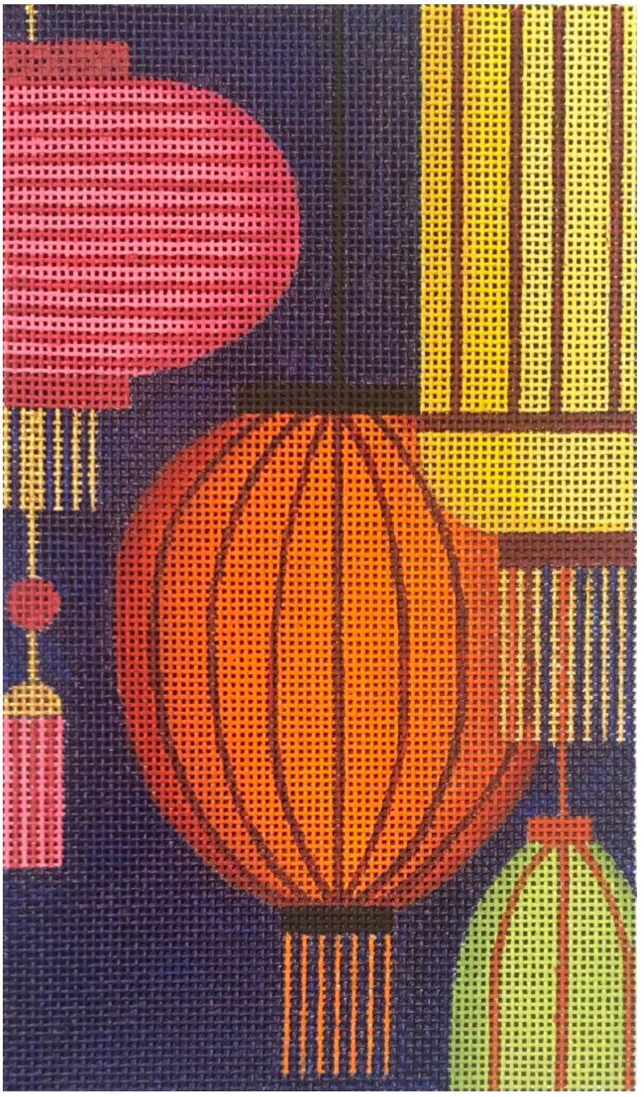 Colorful hanging lanterns on dark navy patterned fabric