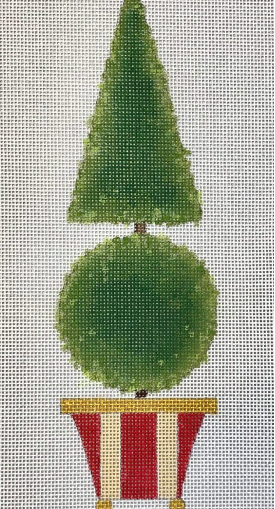 Green topiary tree with round middle and striped red pot