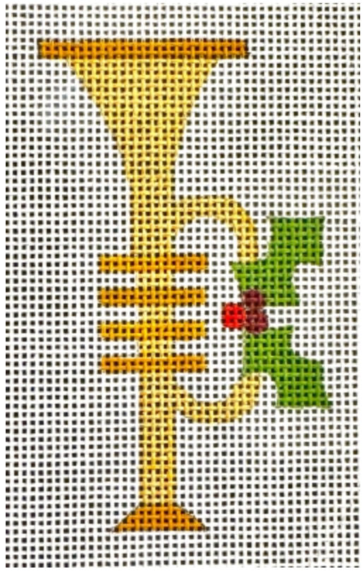 Gold trumpet with green holly leaves and red berries