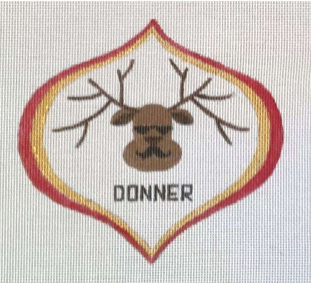 A reindeer needlepoint patch with DONNER lettering and gold border