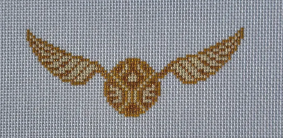Golden-brown winged emblem on light blue-gray fabric