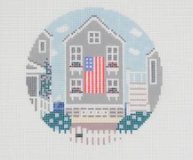 Cross-stitch design of a cozy house with an American flag