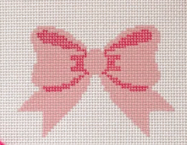 A close-up of a pink embroidered bow design on a white cross-stitch canvas.