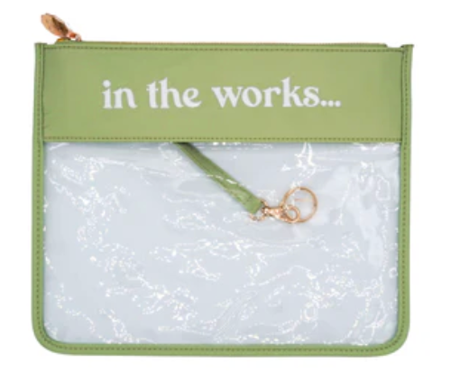 Green pouch with 'in the works...' text and clear front panel.