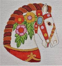 Colorful embroidered horse head with floral details on white canvas